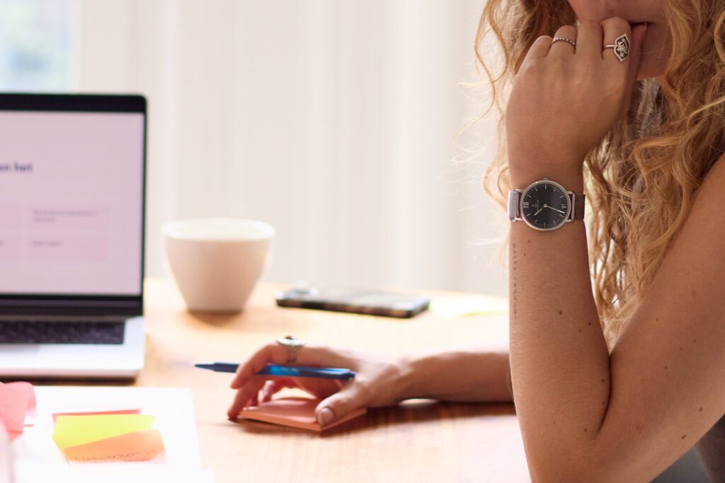Werkplek van een virtual assistent met laptop en aantekeningen